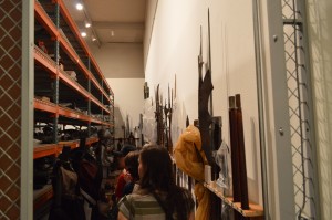 The group looks at the armor and swords